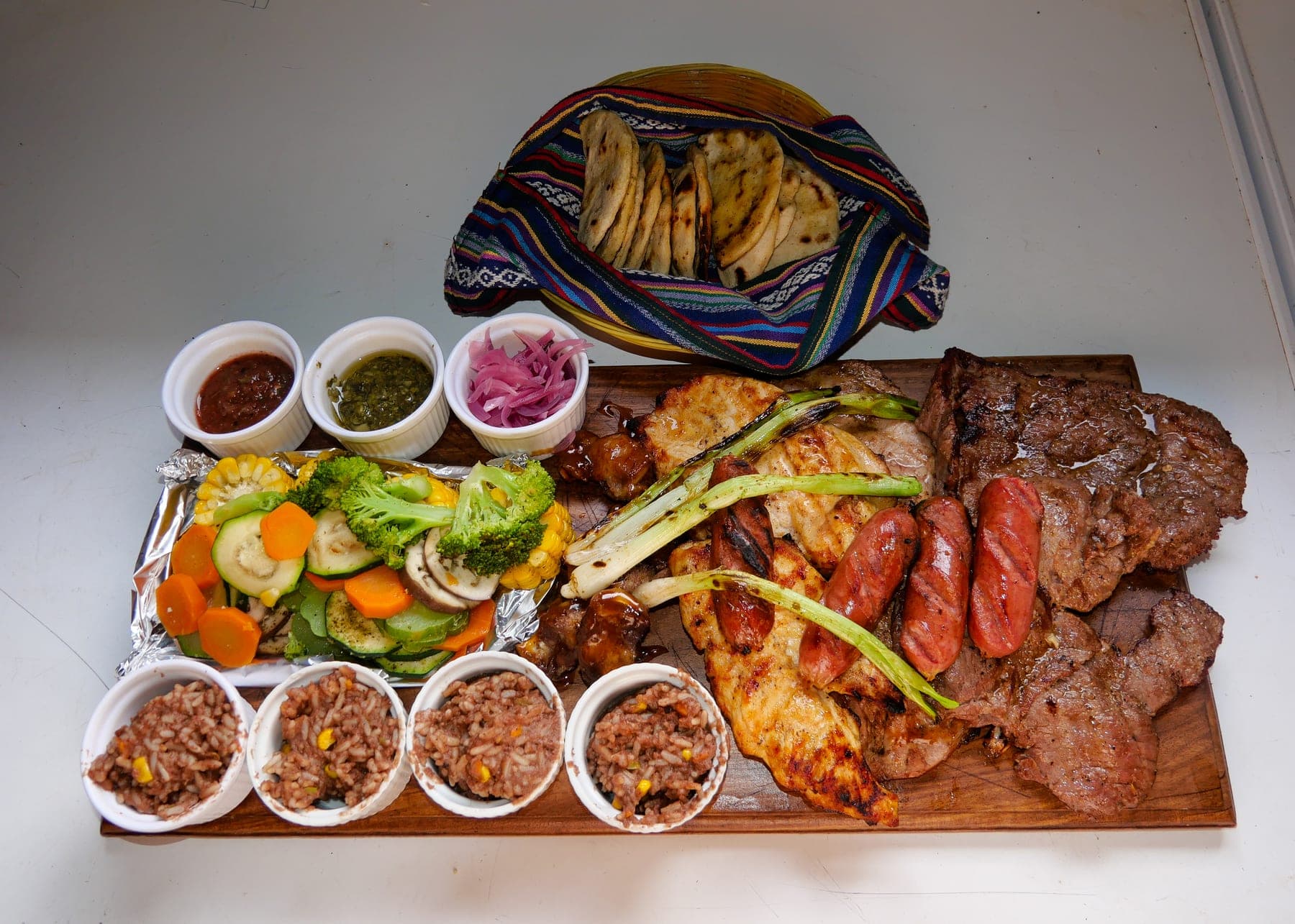 Parrillada platter from En Llamas 87: mixed grilled meats, sausages, grilled vegetables, salsas, and warm tortillas